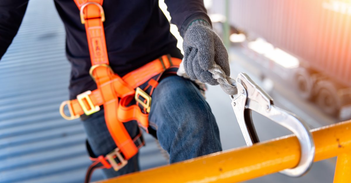 worker with harness on industrial building roof